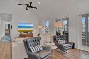 a living room with a white couch and chairs at Luxury home with great resort amenities in Port Aransas