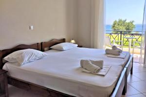 a bedroom with a bed with a view of the ocean at Fotmar in Plakias