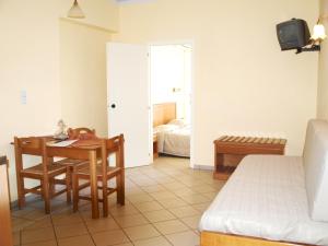 a bedroom with a table and a bed and a room at Kleoniki Mare in Rethymno