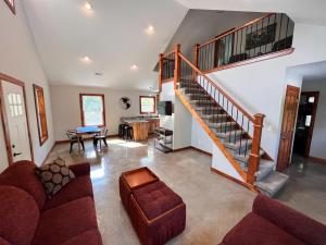 a living room with a staircase and a couch at Brightstone Lake Cabin 1 in Fair Oaks