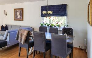 a dining room with a table and chairs and a couch at 4 Bedroom Pet Friendly Home In Sgne in Søgne