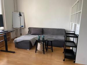 a living room with a bed and a table at Modern Studio Apartment in Berlin with Garden Near Sea in Berlin