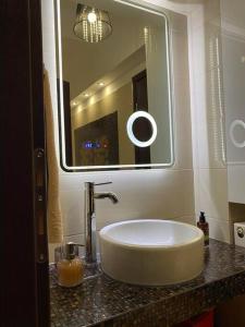 a bathroom with a sink and a large mirror at Harmony by the Sea in Chalkida
