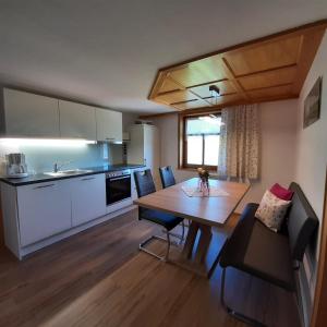 a kitchen and dining room with a table and chairs at Antoniushof in Sulzberg