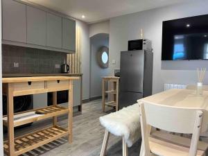 a living room with a table and a refrigerator at “The Art House 6” Galway, Woodquay in Galway