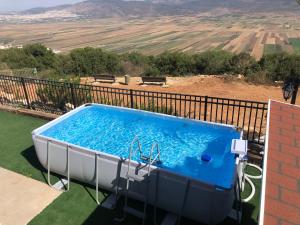 a blue and white tub on a balcony with a view at צימרימון in Bet Rimmon