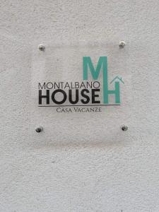 a sign for a monadalano house on a wall at Montalbano House - Casa Vacanze in Santa Margherita di Belice