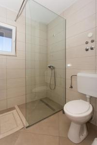 a bathroom with a glass shower with a toilet at Fifty one in Trogir