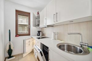 a small kitchen with a sink and a window at NEW STUDIO@Baroque City Center in Dresden