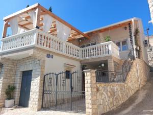 a house with a balcony on top of it at Holiday Home Peran in Grebaštica