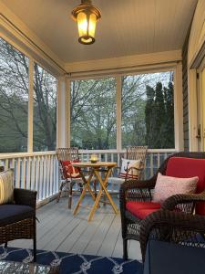 a screened in porch with chairs and a table at White Sails Inn in Kennebunk