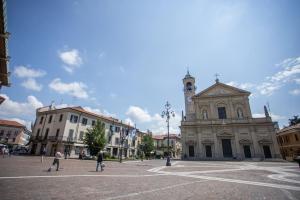 a building with a clock tower in a town square at FIORINA in Saronno