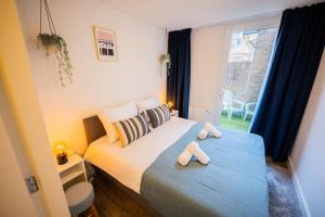 a bedroom with a bed with two slippers on it at Elegant 2 Bedroom Apartment 75m2 - SD23G in Eindhoven