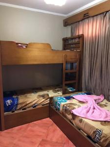 a bedroom with two bunk beds and a window at Porto Marina pool and sea view apartment in El Alamein
