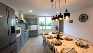 a kitchen with a table with chairs and a dining room at Villa Fjaka in Umag