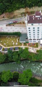 an aerial view of a building next to a river at Jolnar garden hotel in Macka
