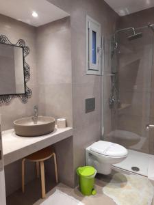 a bathroom with a sink and a toilet and a shower at Villa Elsi upper apartment in Kalami
