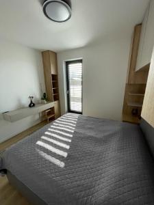 a bedroom with a large bed with a window at Meet & Golf in Šajdíkove Humence