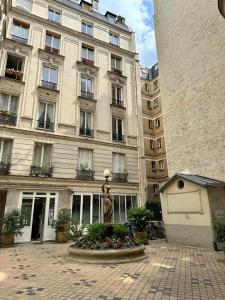 a large building with a statue in front of it at Appartement cosy - Sacré coeur in Paris