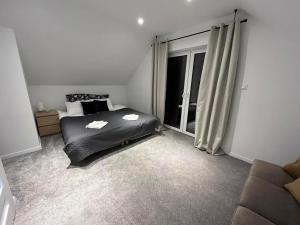 a bedroom with a bed and a large window at Mazurska Osada Domki in Rydzewo +1 photo