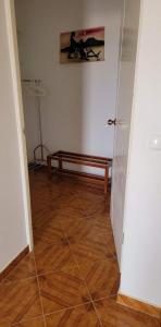 a hallway with a bench in the corner of a room at Djarfogo house in S&atilde;o Filipe