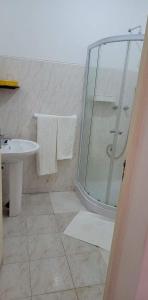 a bathroom with a shower and a sink at Djarfogo house in São Filipe