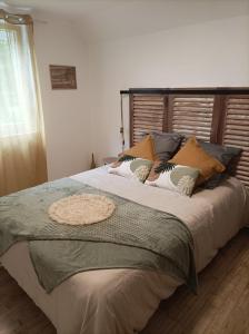 um quarto com uma cama grande e almofadas em La Cressonnière 56 em Missiriac
