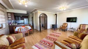 a living room with a couch and a table at Heaven Twın Villa in Zafanos