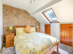 a bedroom with a bed and a window at Kingfisher Barn - Uk44098 in Carsington