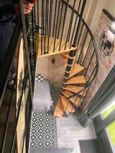 a spiral staircase in a house with a stair case at Top Loft Perles 4 des Châteaux in Mer