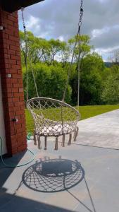 a basket swing hanging from a brick building at Riverside in Slavske
