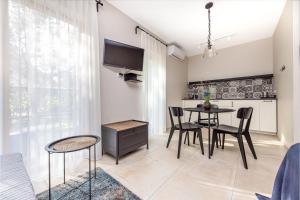a kitchen and dining room with a table and chairs at Atpūtys in Palanga