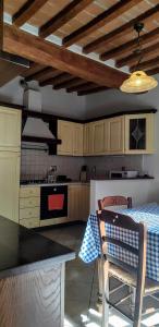 a kitchen with wooden cabinets and a table with a blue and white table cloth at Il Castello in Bucine +33 photos