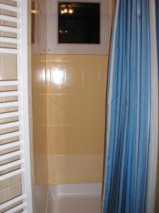 a bathroom with a shower and a tub and a window at Ferienwohnung Pezi in Sankt Primus am Turnersee