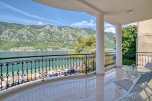 a balcony with a view of the water and mountains at The Golden Luxury complex - Central and Seaboard in Kotor