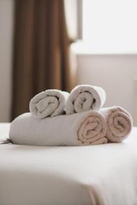 a pile of towels sitting on top of a toilet at Penthouse at Chelsea Cloisters Hotel in London