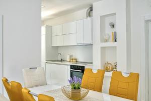 a kitchen and dining room with a table and chairs at The Golden Luxury complex - Central and Seaboard in Kotor