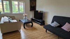 a living room with a couch and a coffee table at Strandnära boende med egen uteplats in Sölvesborg