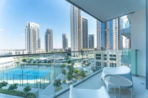 a balcony with a view of a city at Vogue Waterfront Living - The Grand Dubai Creek Harbour in Dubai