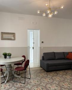 a living room with a couch and a table at Caves Garden in Bari