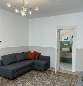 a living room with a couch and a mirror at Caves Garden in Bari