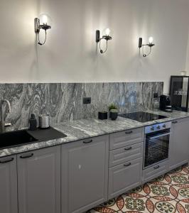 a kitchen with white cabinets and a counter top at Caves Garden in Bari +31 photos