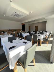 a dining room with white tables and chairs at Sea Resort 1 & Spa in Władysławowo