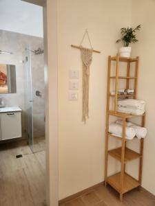 a bathroom with a shower and a cross on the wall at מדברא - צימר בירוחם in Yeroẖam