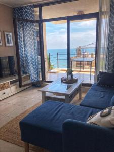 a living room with a view of the ocean at Dolce Vita Blue Boho, Premium Apartment with seaview in Sveti Vlas