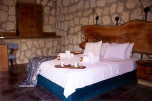 a bedroom with a bed with a tray of food on it at Etiz Hotels Alaçatı in Cesme