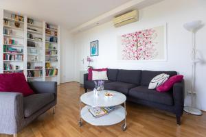 a living room with two couches and a table at SunSpot Apartment - beautiful view with big garden, free parking, central in Dubrovnik