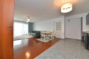 a living room with a table and a dining room at Apartament LUX 1 Mai Pod in Bucharest