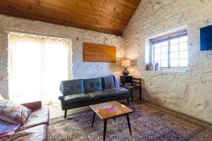 a living room with a couch and a table at Macquarie Street Stable in Hobart