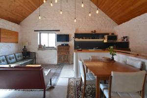 a living room with a table and a couch at Macquarie Street Stable in Hobart